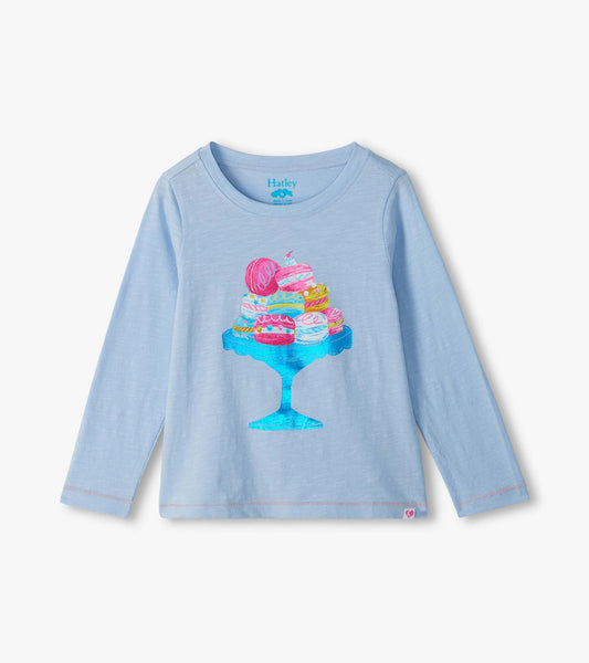 Light blue girls long-sleeve T-shirt with colorful macaron graphic on a blue cake stand