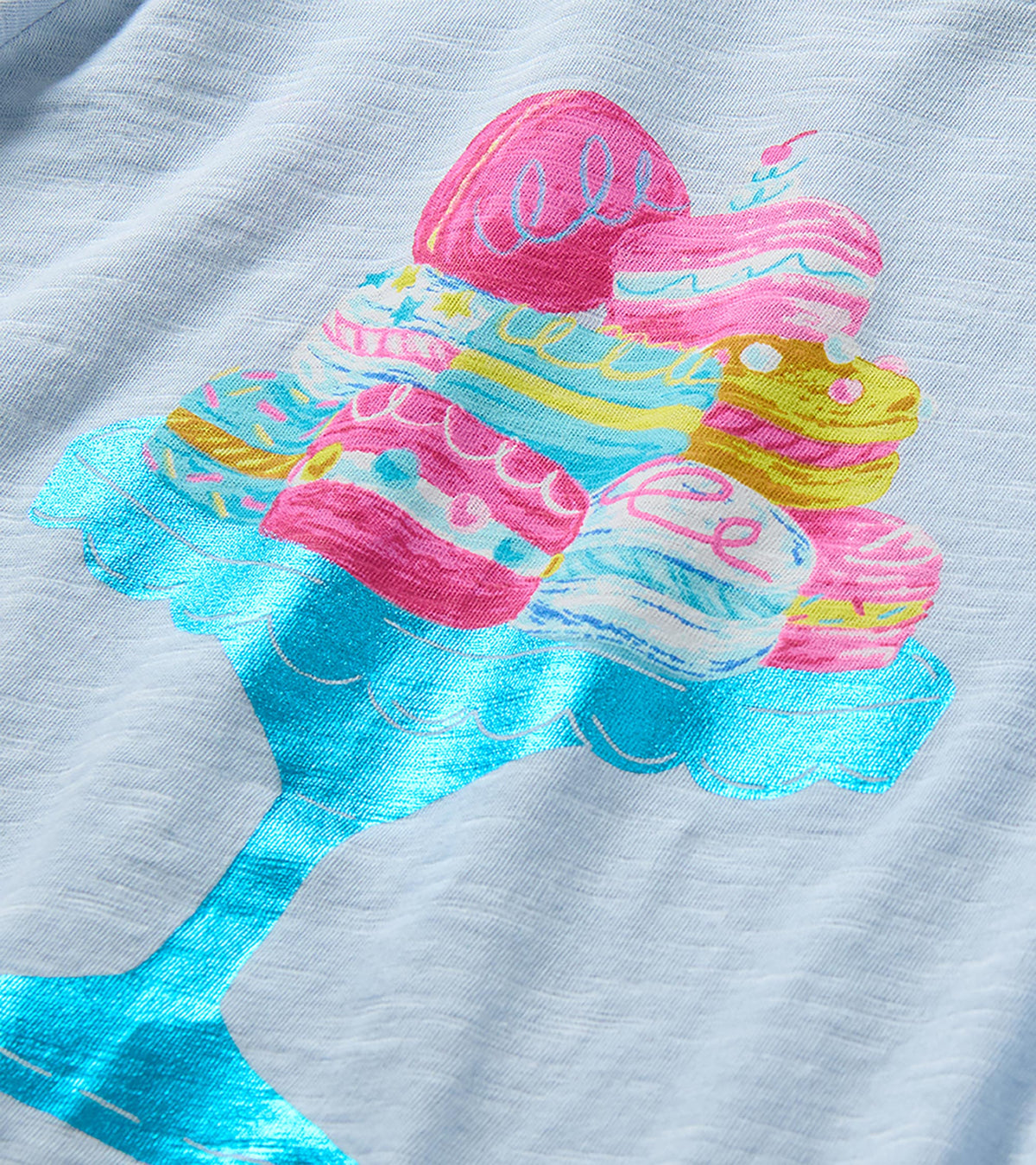 Close-up of colorful macaron graphic on a shiny blue cake stand