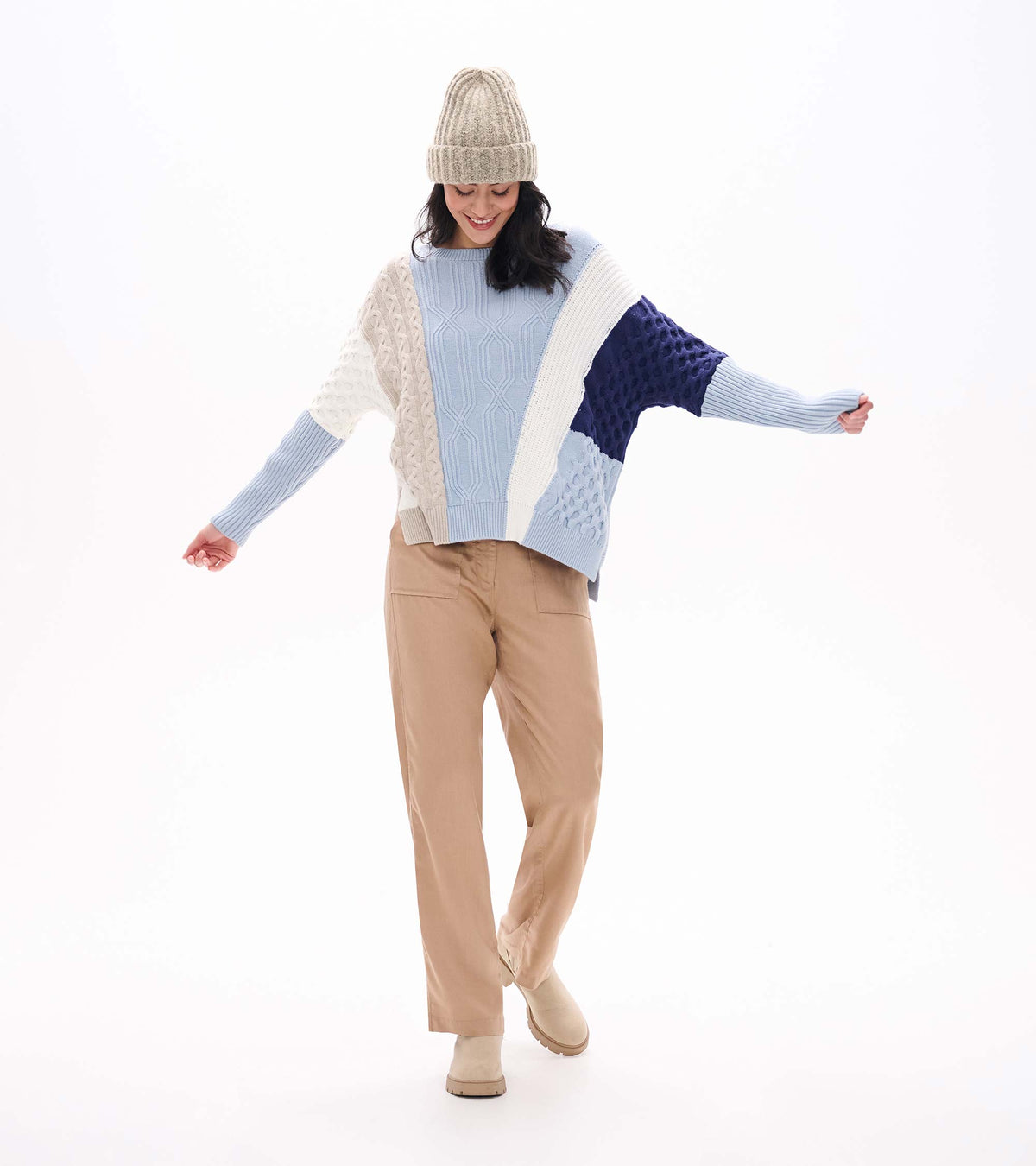 Front view of blue mixed-pattern sweater with cream and navy color blocking and long ribbed sleeves