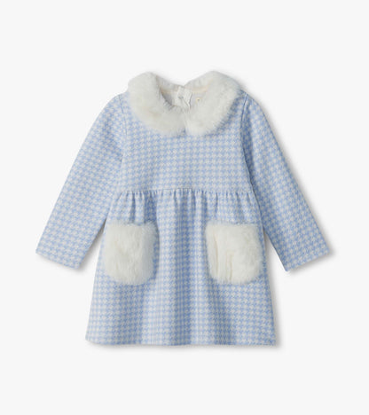 Front view of blue and white houndstooth long-sleeve dress with white fluffy collar and patch pockets