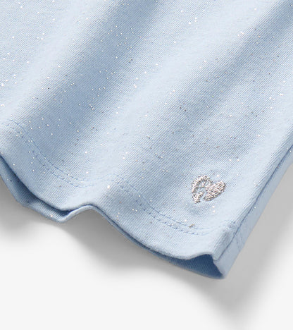 Close-up of light blue sparkle T-shirt hem with silver heart embroidery detail