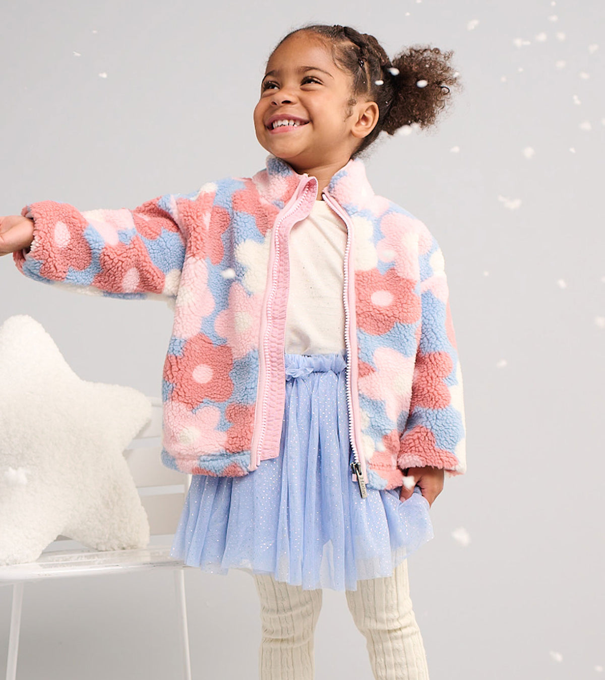 Toddler wearing a Kentucky blue tutu skirt with a pink and blue fleece jacket and cream ribbed tights