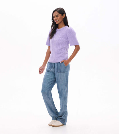 Side front view of lilac cable knit sweater with short puff sleeves