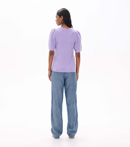 Back view of lilac cable knit sweater with short puff sleeves and ribbed hem
