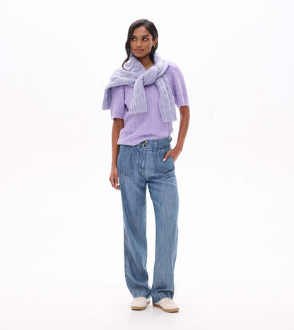 Lilac cable knit short-sleeve sweater styled with a matching knit draped over the shoulders