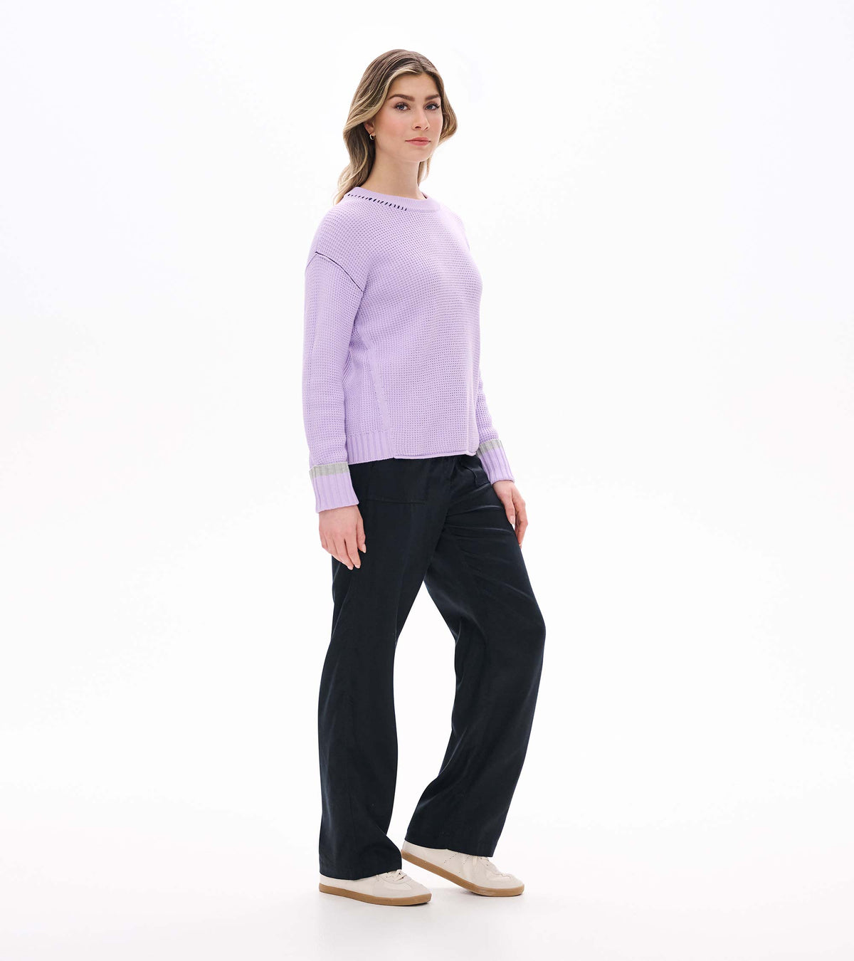 Side view of lilac waffle knit sweater with crew neck, drop shoulders, and ribbed cuffs with gray stripe