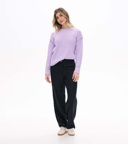 Angled front view of lilac waffle knit sweater with crew neck and ribbed cuffs with gray stripe