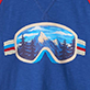 Blue ski goggles with snowy mountain reflection and red, white, and blue strap on a blue background