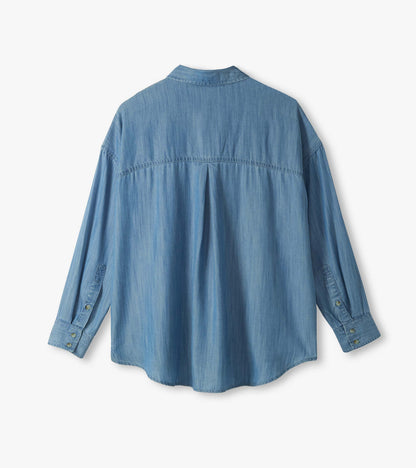 Back view of light blue wash relaxed button-down shirt with long sleeves, curved hem, and back pleat