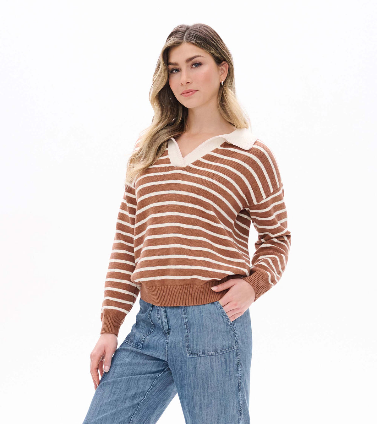 Model wearing camel and cream striped Johnny collar sweater with long sleeves and ribbed hem