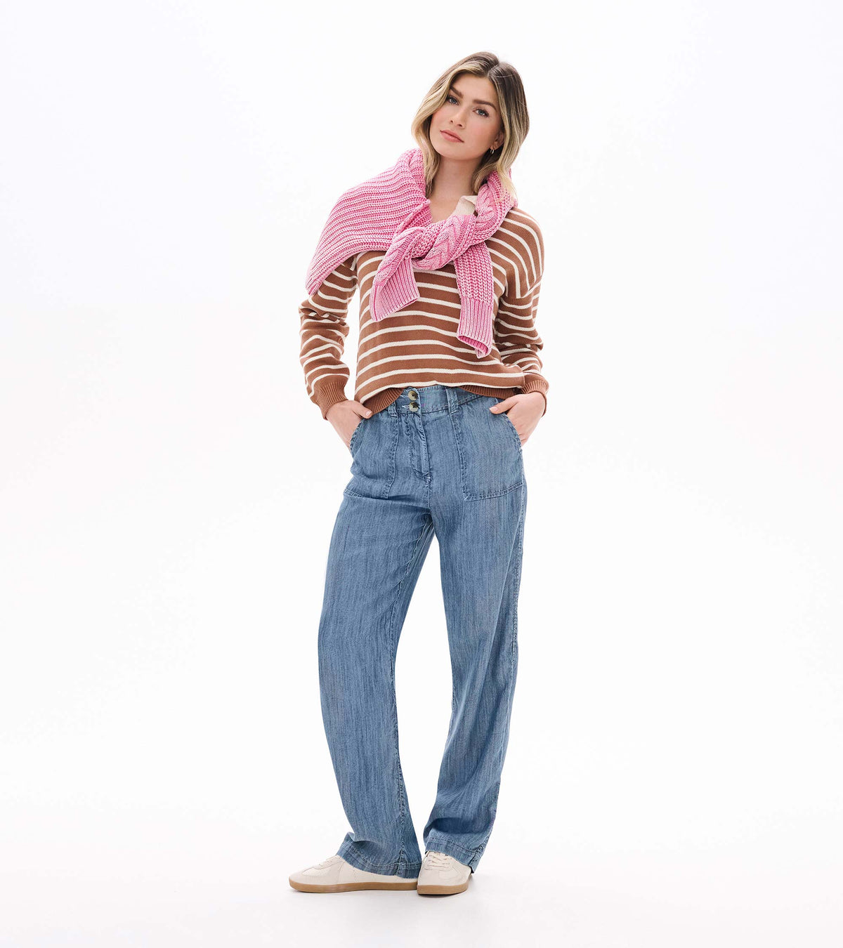 Camel and cream striped Johnny collar sweater styled with a pink sweater draped over the shoulders