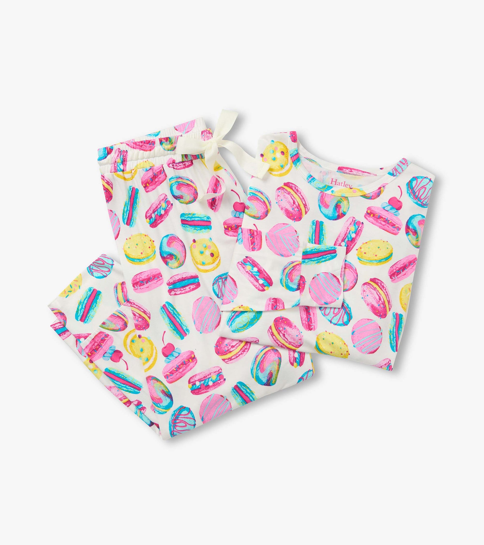 Folded cream pajama set with pink, yellow and blue macaron print and white drawstring waistband