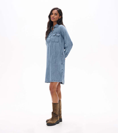 Blue acid rinse popover dress shown in side view with long sleeves, collar, and side pocket