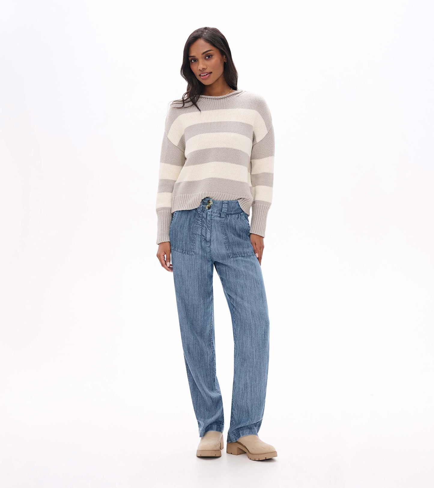 Blue acid rinse wide leg pants with front patch pockets and double-button waistband, shown on model