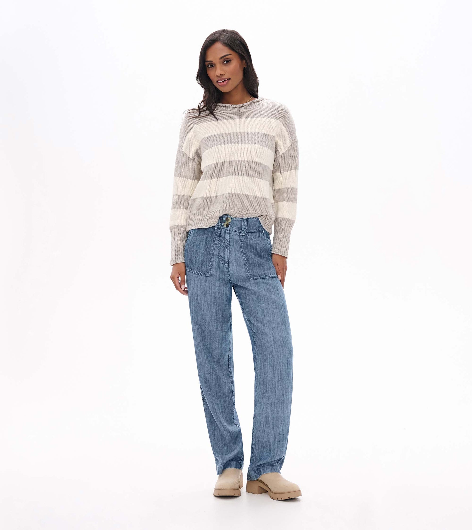 Blue acid rinse wide leg pants with front patch pockets and double-button waistband, shown on model