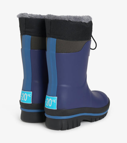 Back view of navy kids boots with gray faux-fur trim, blue heel stripes, and black lug soles