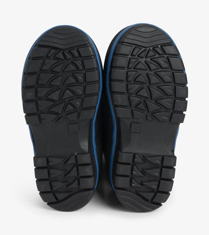 Bottom view of black lug soles with textured tread pattern on navy kids boots