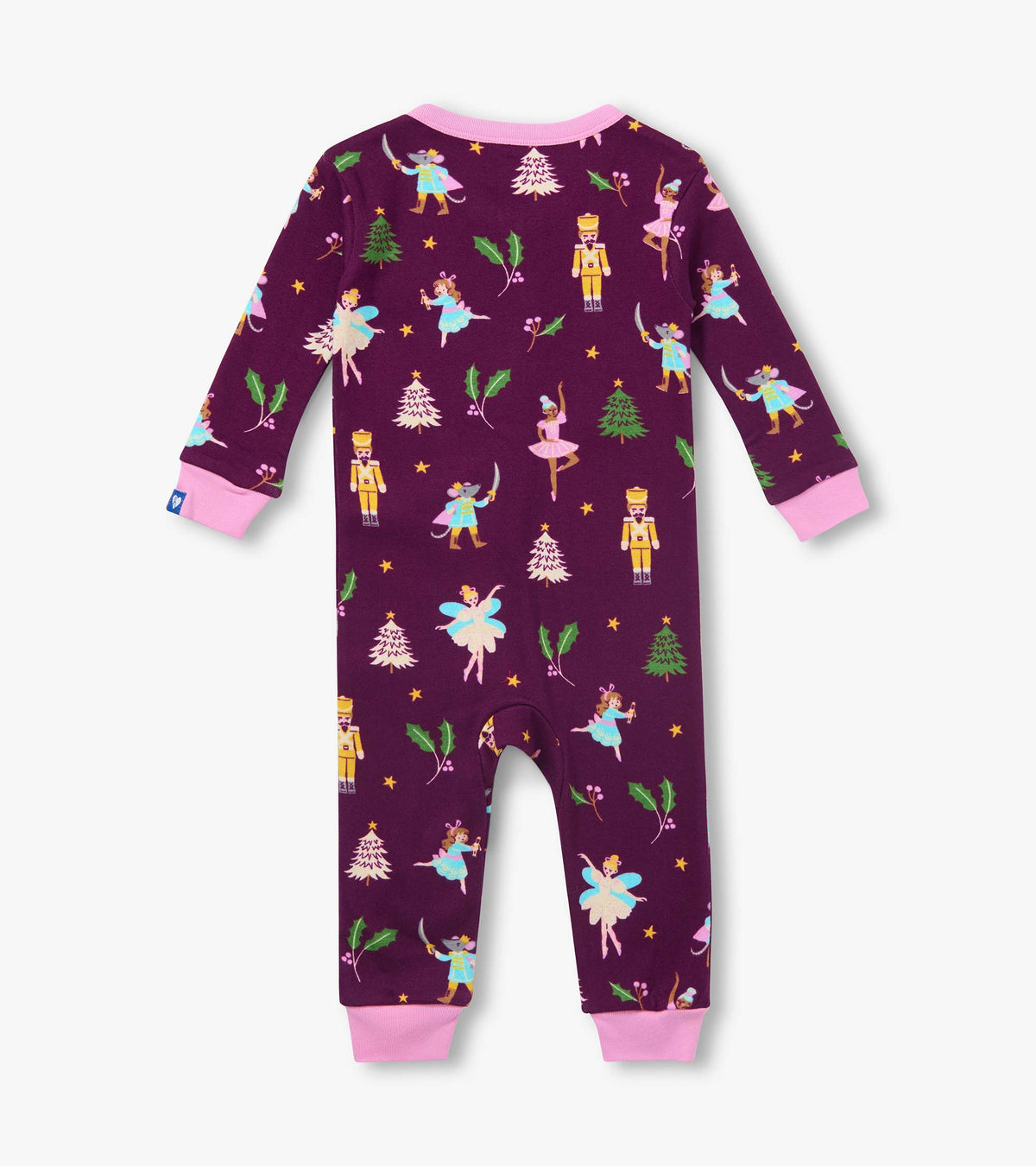 Back view of infant coverall in deep purple with pink cuffs and holiday print of nutcrackers, ballerinas and trees
