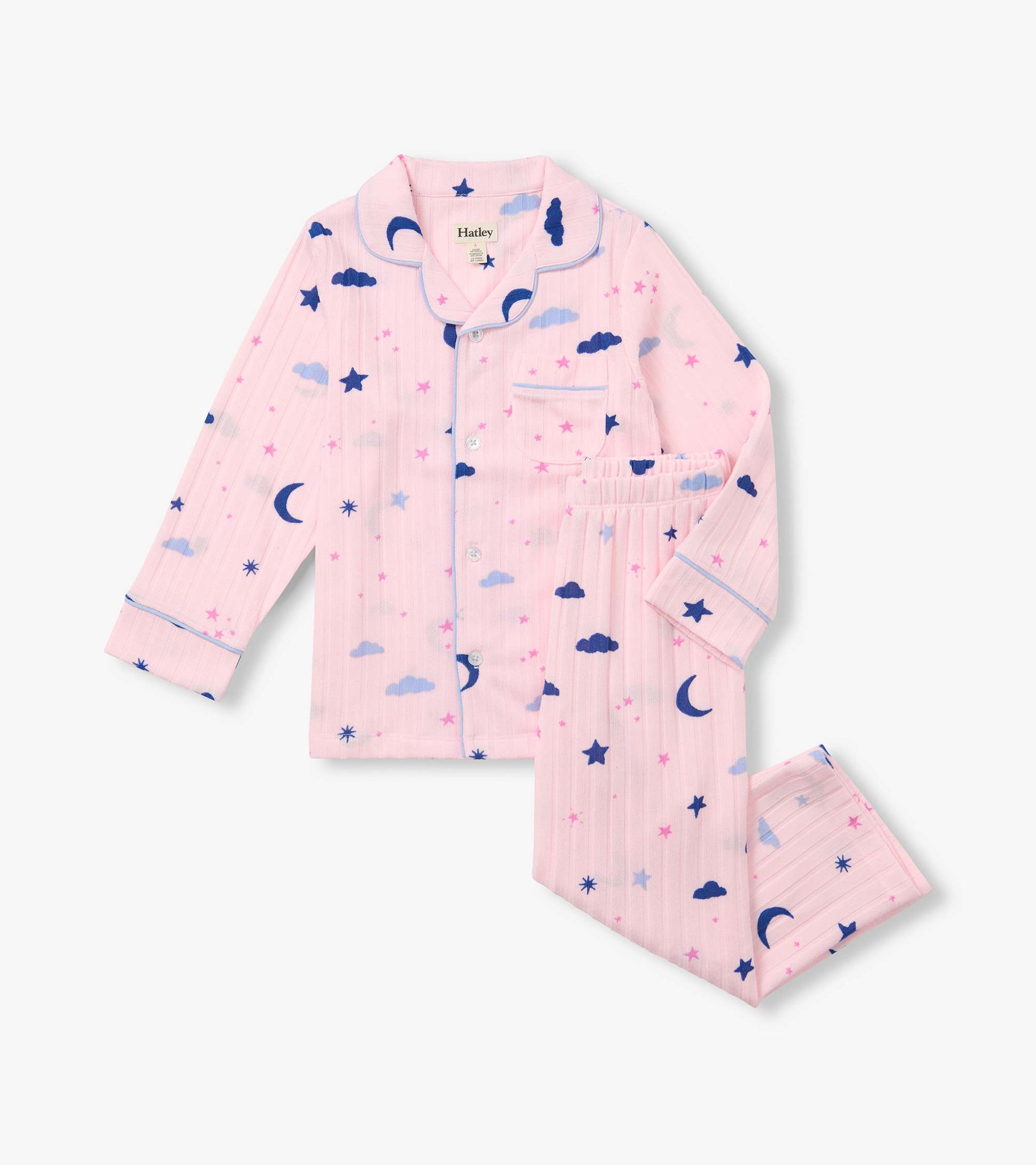 Pink kids pajama set with button-front top and pants, printed with blue moons, clouds, and stars