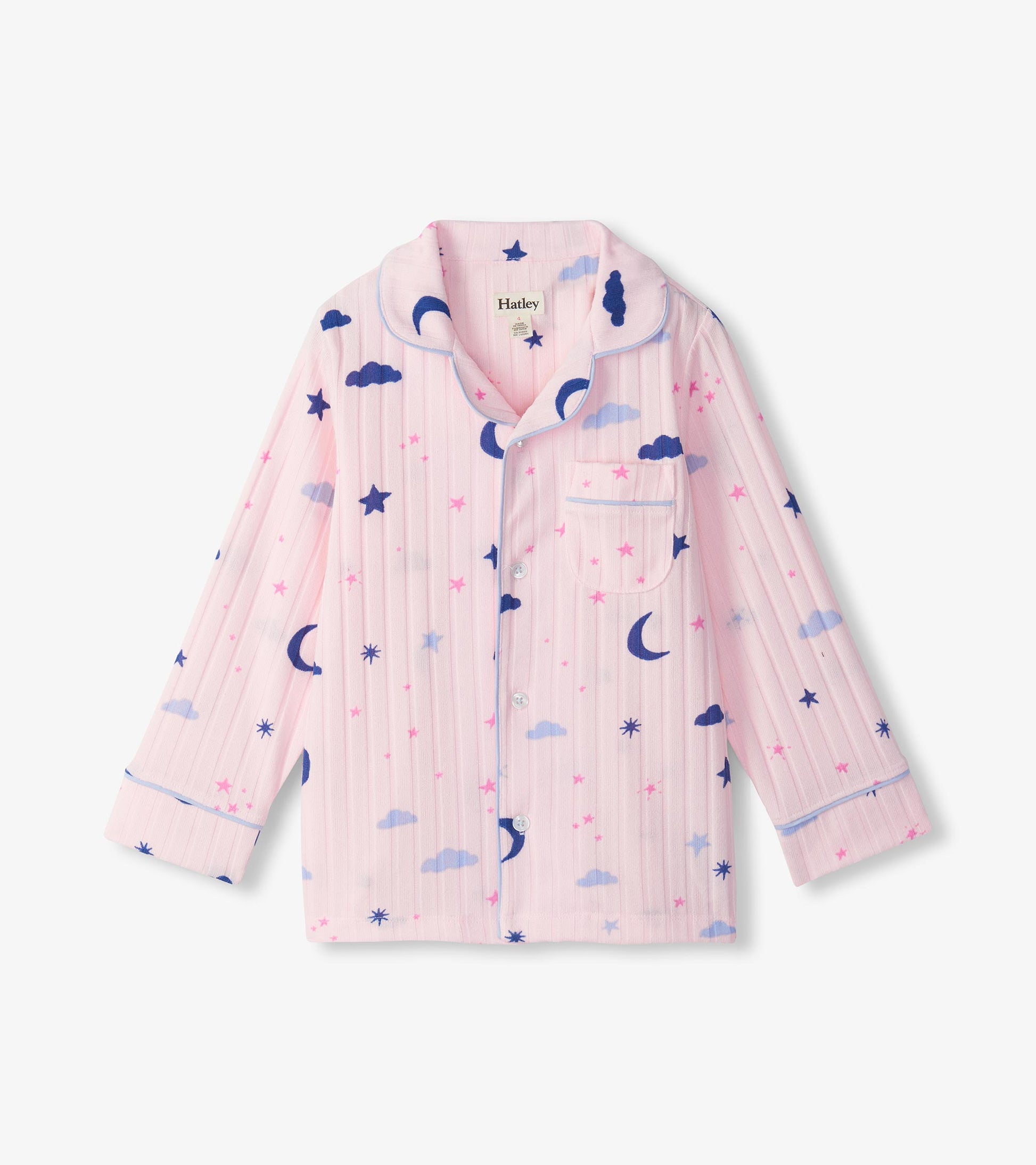 Close-up of pink pajama top with blue piping, chest pocket, and moon, star, and cloud print