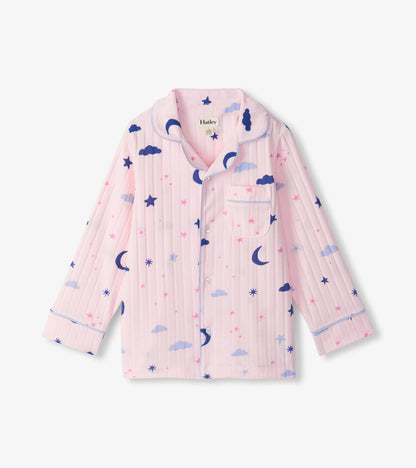 Close-up of pink pajama top with blue piping, chest pocket, and moon, star, and cloud print
