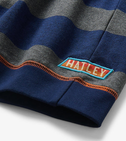 Close-up of sleeve cuff with navy and charcoal stripes, orange stitching, and Hatley logo patch