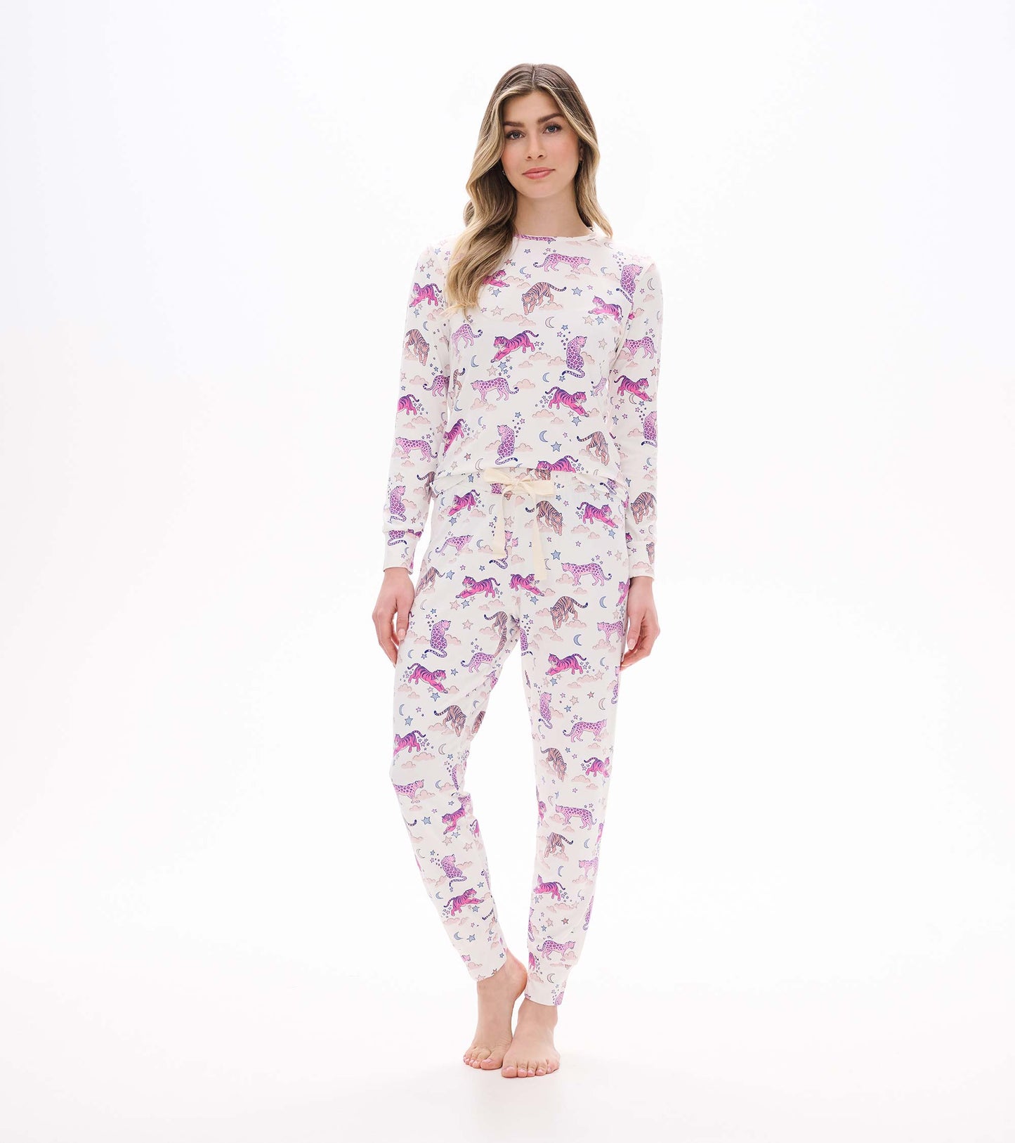 Women's pajama set with cream long-sleeve top and jogger pants in a pink tiger, moon, and star print