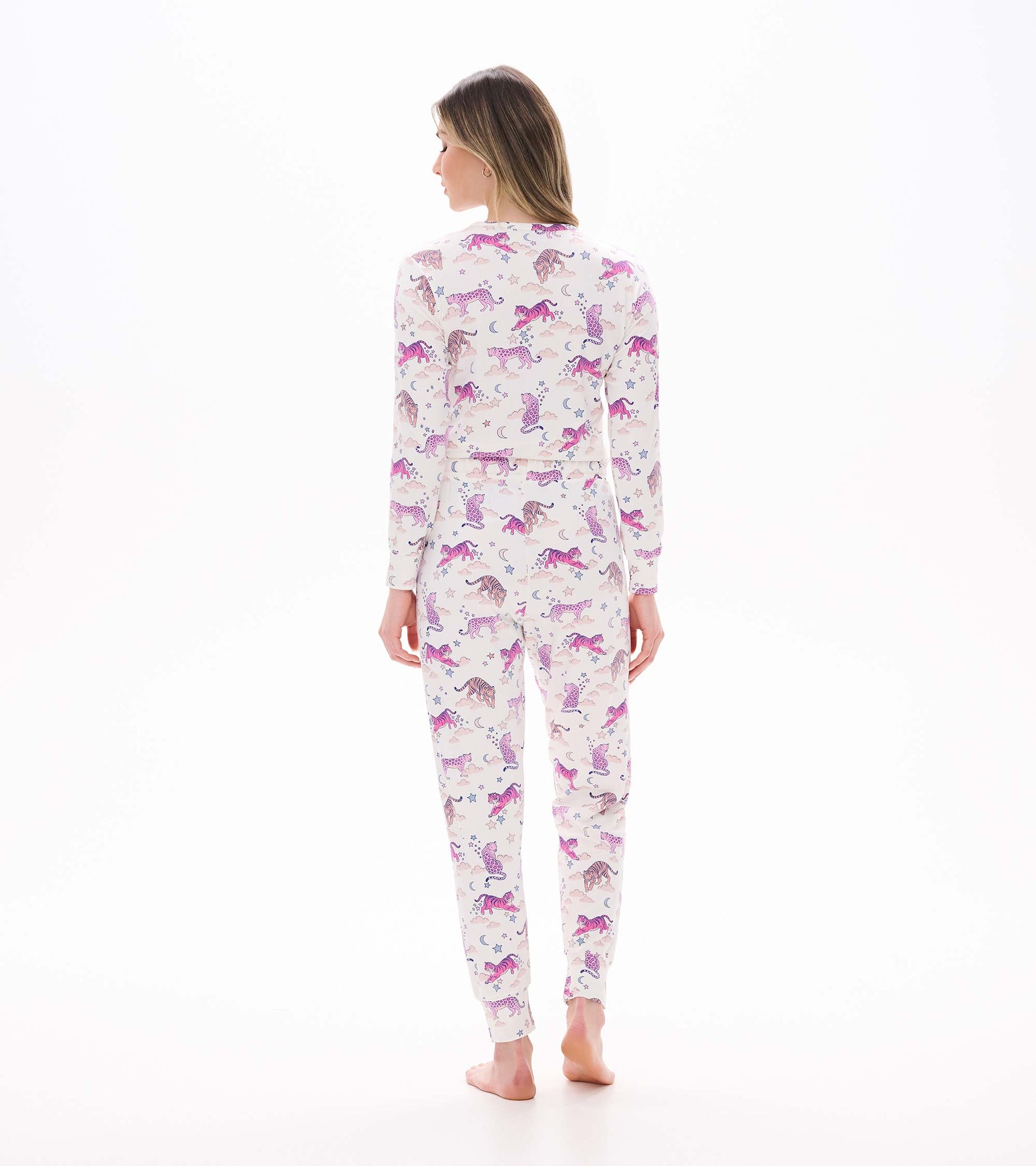 Back view of cream pajama set with pink tiger, moon, and star print and fitted jogger-style pants