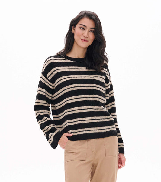 Model wearing black and oatmeal striped crewneck sweater with long sleeves, front view