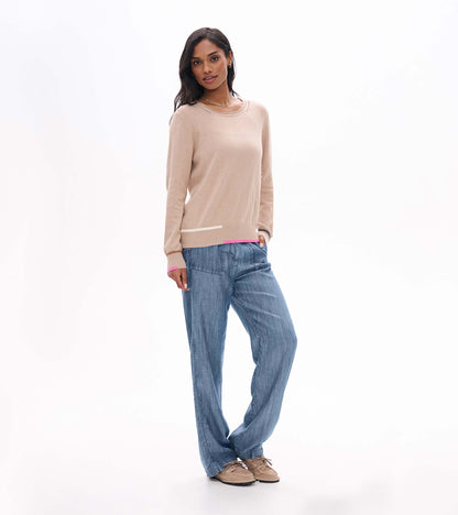 Full front view of oatmeal crew neck sweater styled with blue pants