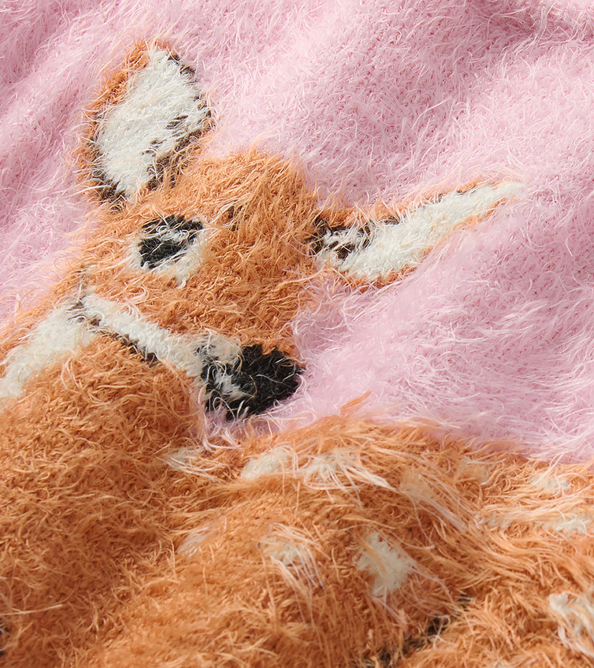 Close-up of the pink sweater showing the fawn graphic and fuzzy knit texture