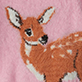 Illustrated brown deer with white spots on a pink background
