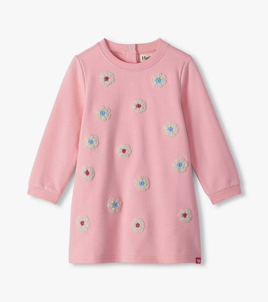 Pink long sleeve infant dress with cream flower appliqués and blue and pink centers