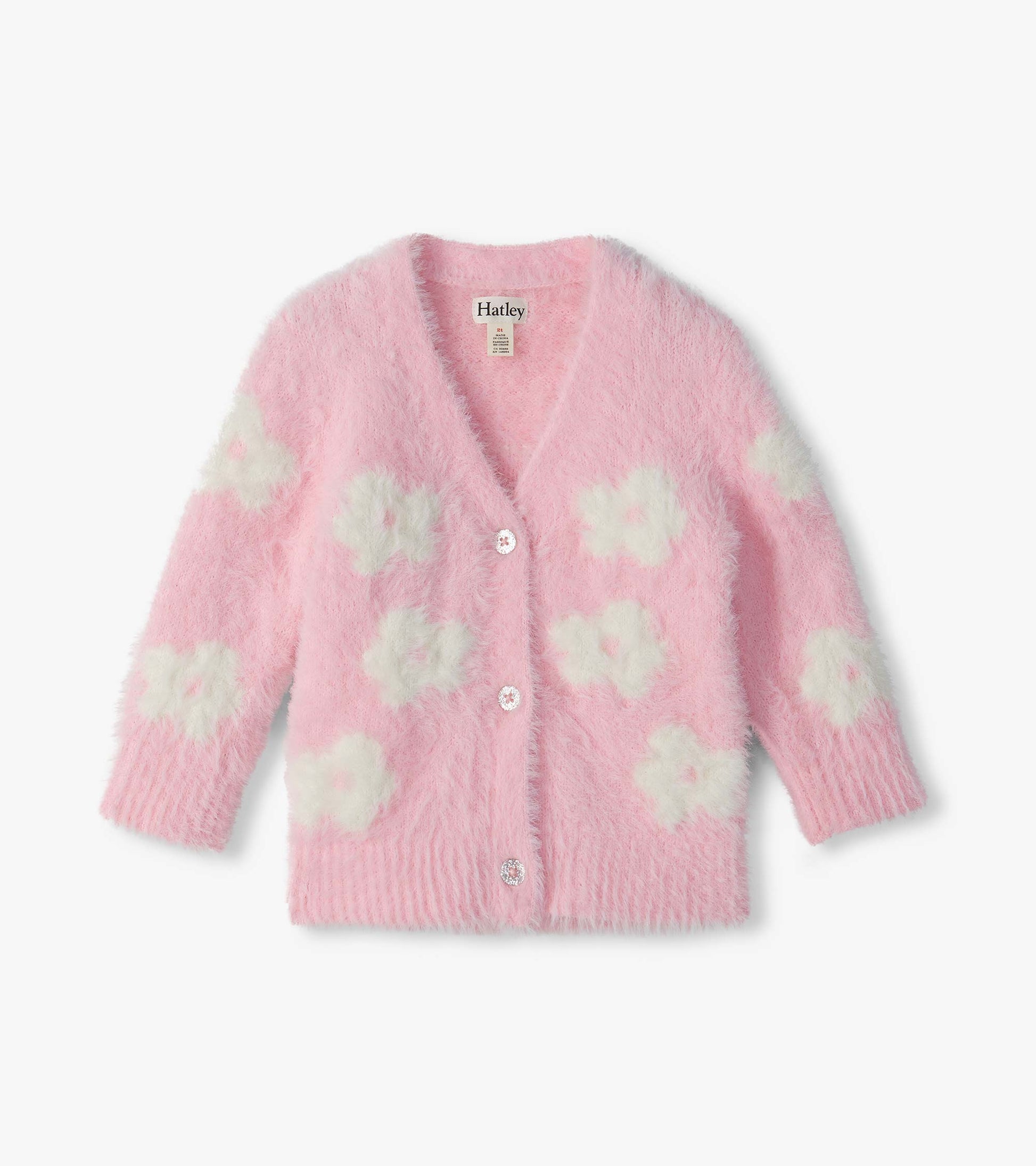 Front view of pink fuzzy cardigan with white flower pattern, V-neck, ribbed cuffs, and button front