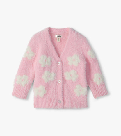 Front view of pink fuzzy cardigan with cream flower pattern, V-neck, long sleeves, and glitter buttons