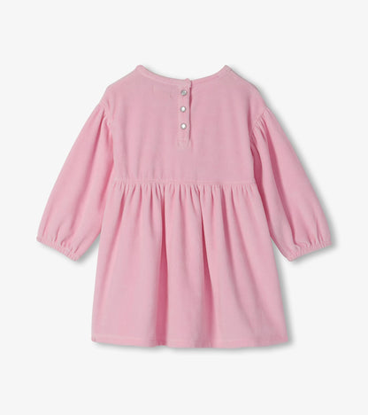 Back view of orchid pink toddler dress with long puff sleeves, gathered skirt and snap placket