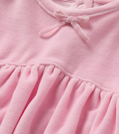 Close-up of orchid pink dress neckline with small bow and gathered waist seam