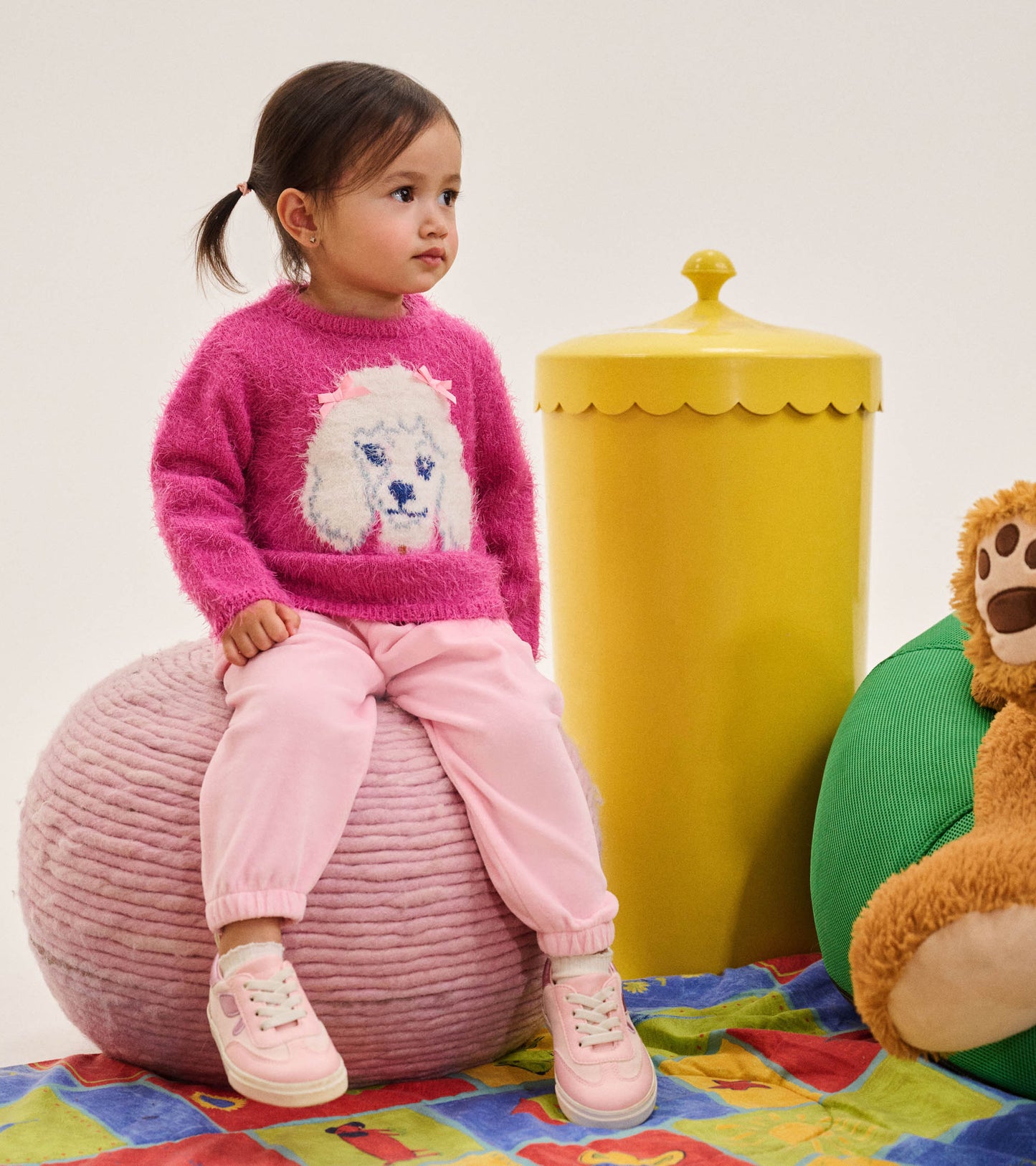 Toddler wearing orchid pink cozy pants with elastic cuffs, styled with a bright pink sweater and pink sneakers