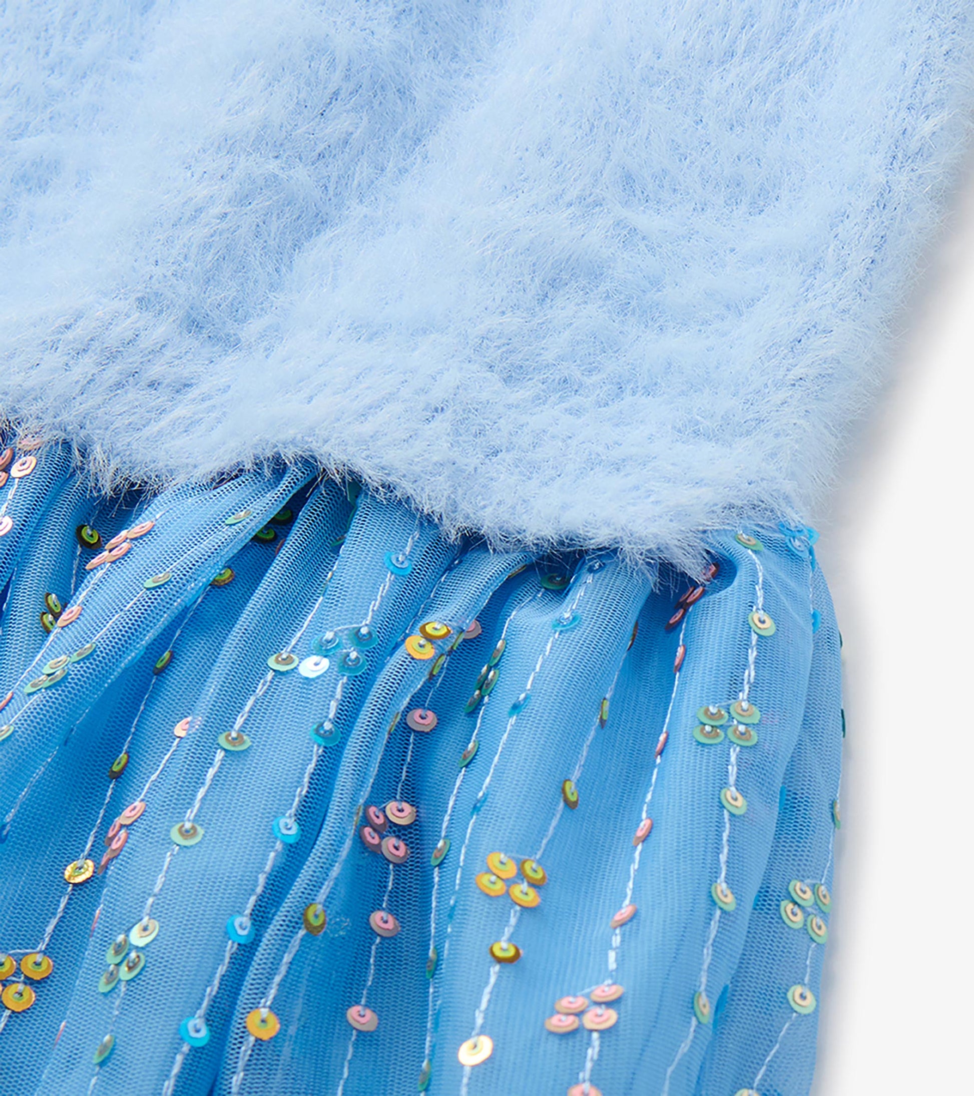 Close-up of blue fuzzy knit bodice and blue mesh skirt with multicolor sequins