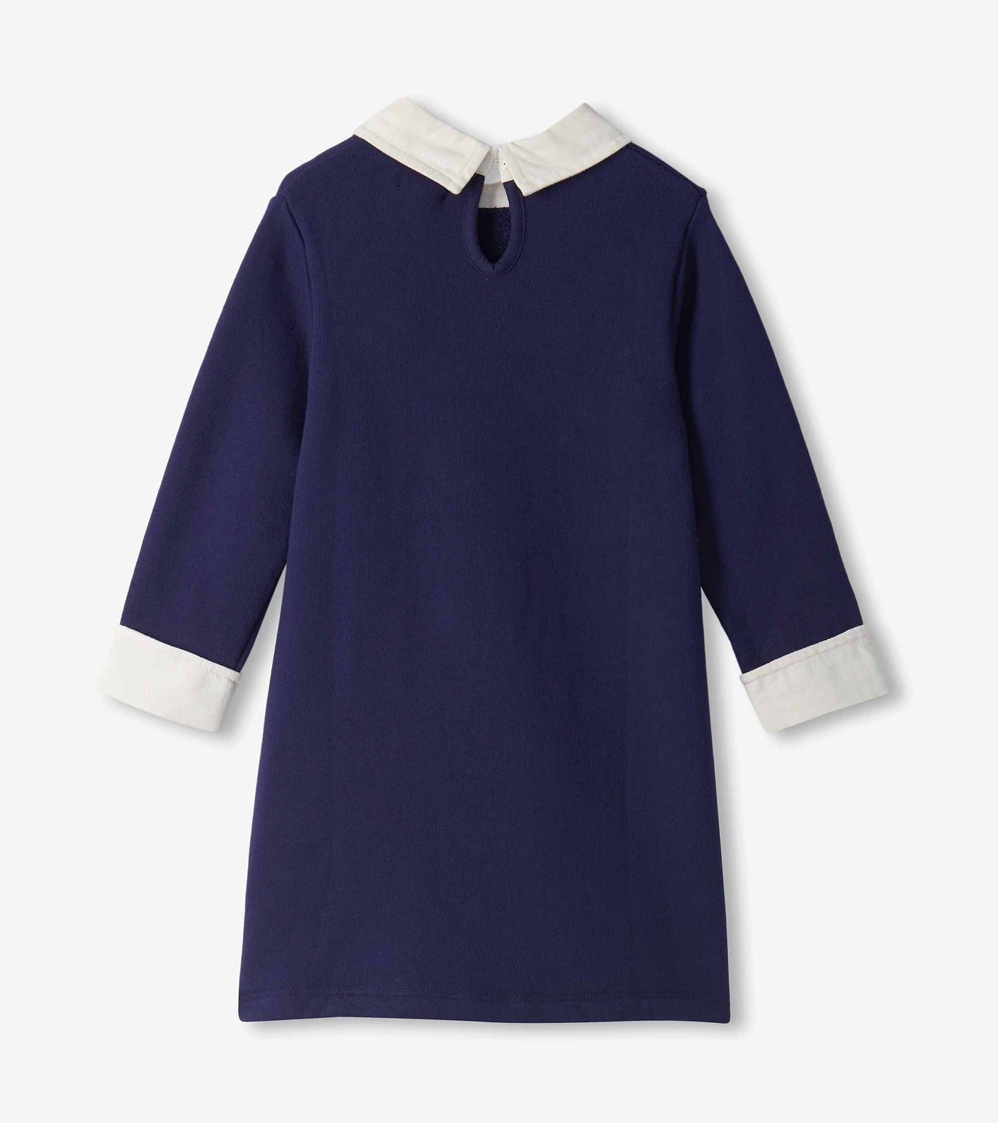 Back view of navy long sleeve dress with white collar, white cuffs, and keyhole button closure