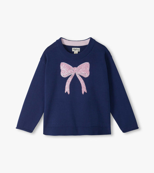 Front view of a navy crew neck girls sweater with a large pink sequin bow on the chest