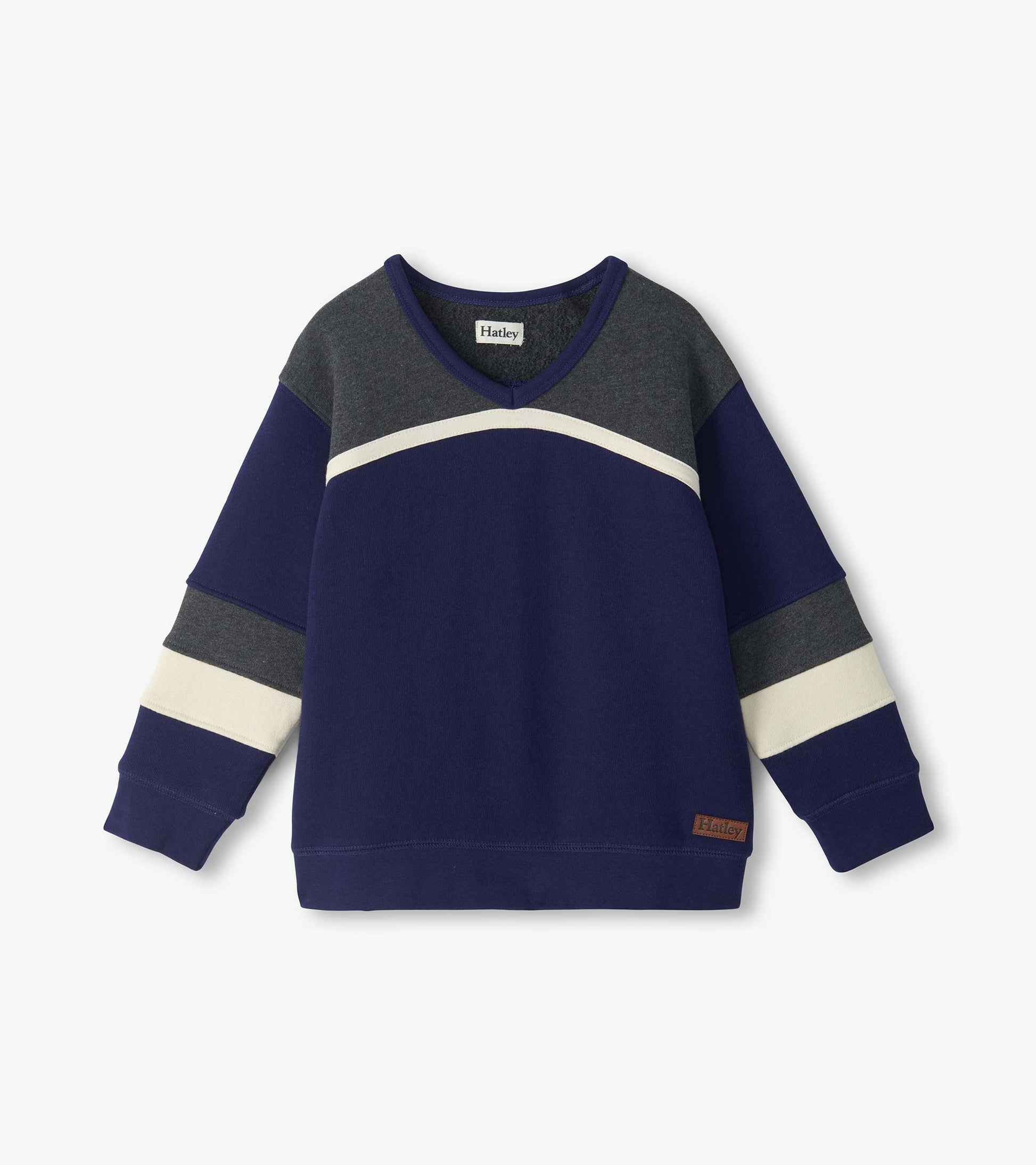 Front view of kids blue pullover top with gray yoke, cream curved chest stripe, and striped sleeves