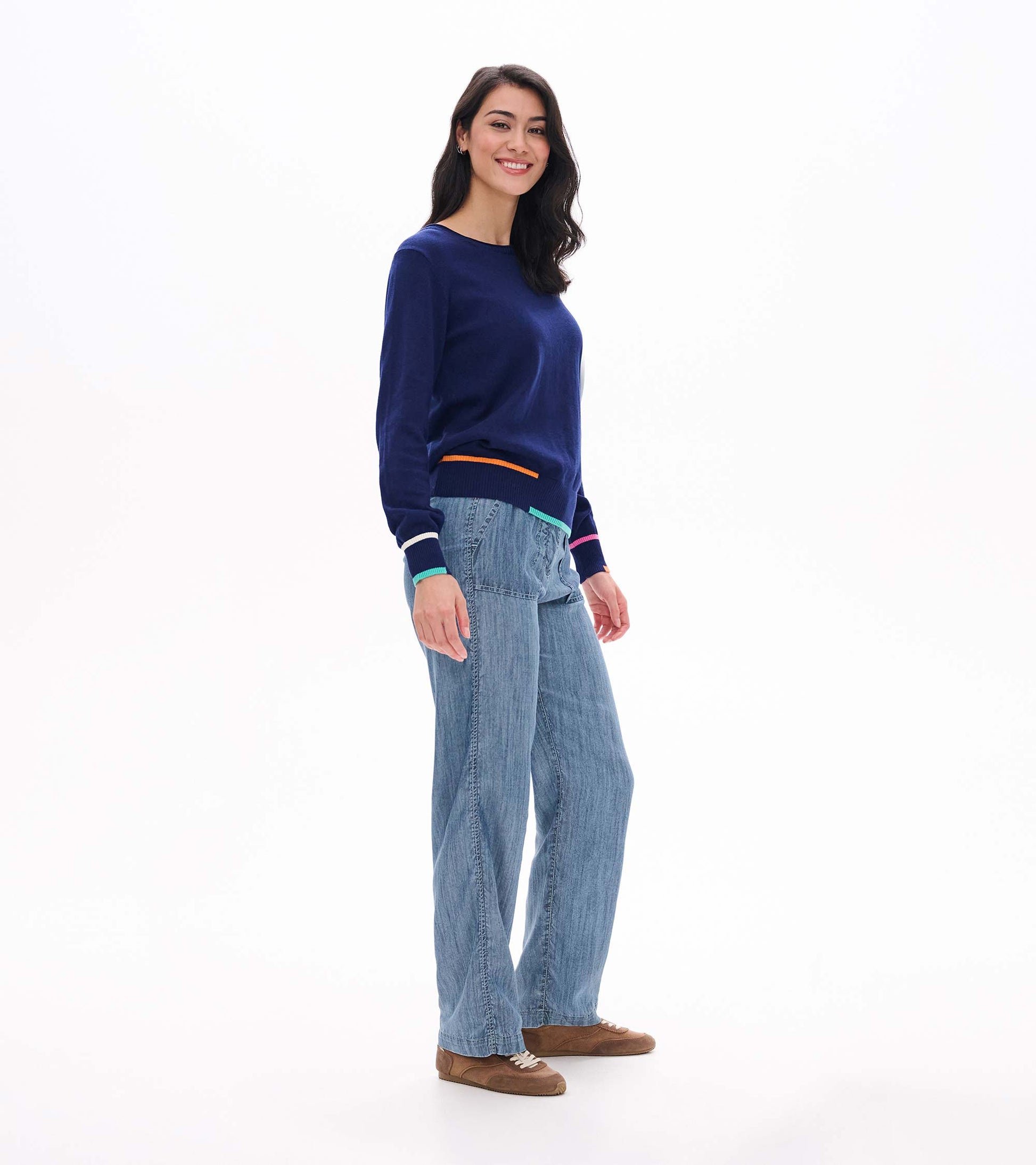 Side view of patriot blue crew neck sweater with multicolor trim at hem and cuffs