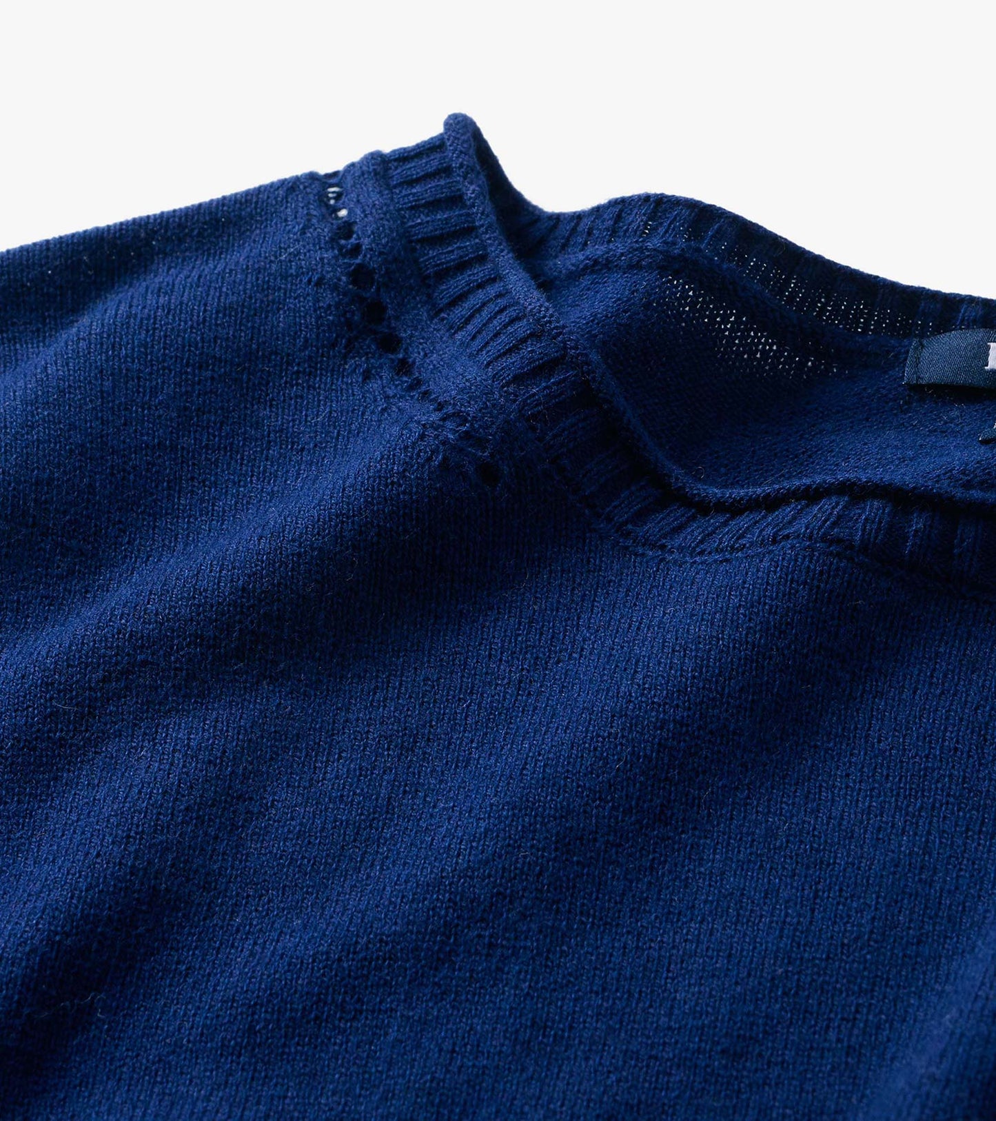 Close-up of patriot blue crew neck sweater neckline with ribbed trim and open knit detail