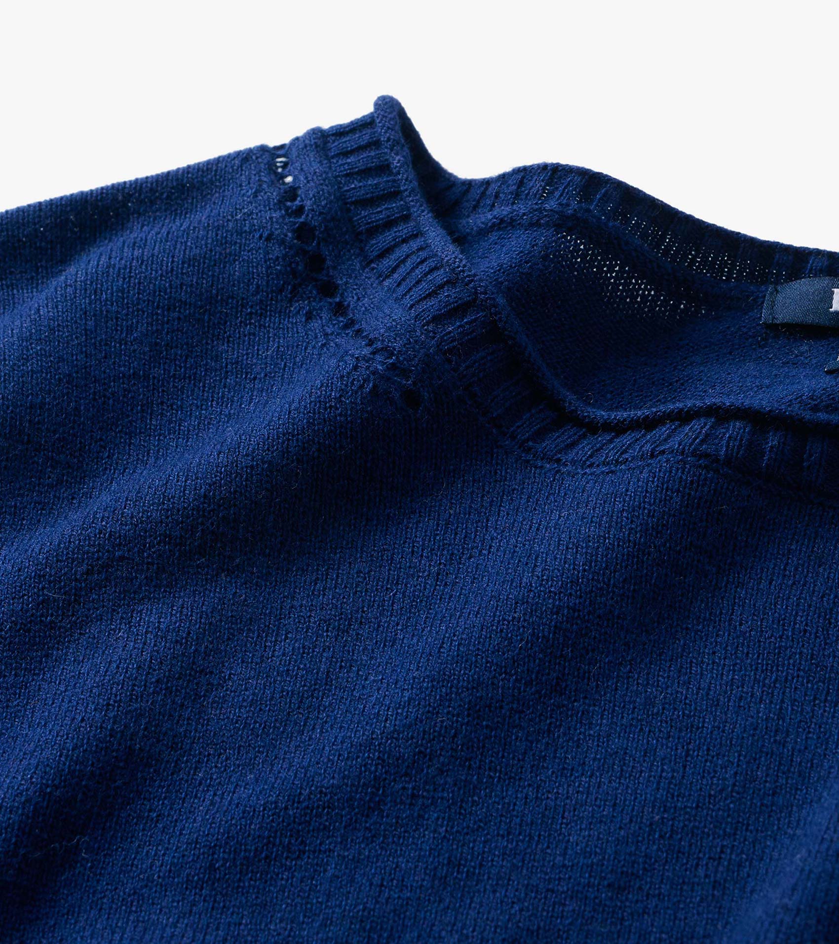 Close-up of patriot blue crew neck sweater neckline with ribbed trim and open knit detail