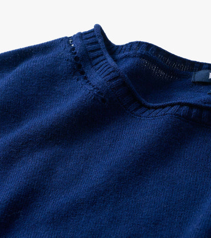 Close-up of patriot blue crew neck sweater neckline with ribbed trim and open knit detail