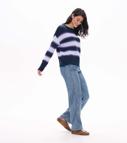 Side view of rolled collar sweater with navy, white, and purple horizontal stripes