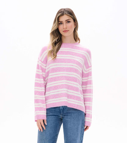 Front view of pink and cream striped sweater with long sleeves and crew neckline on model