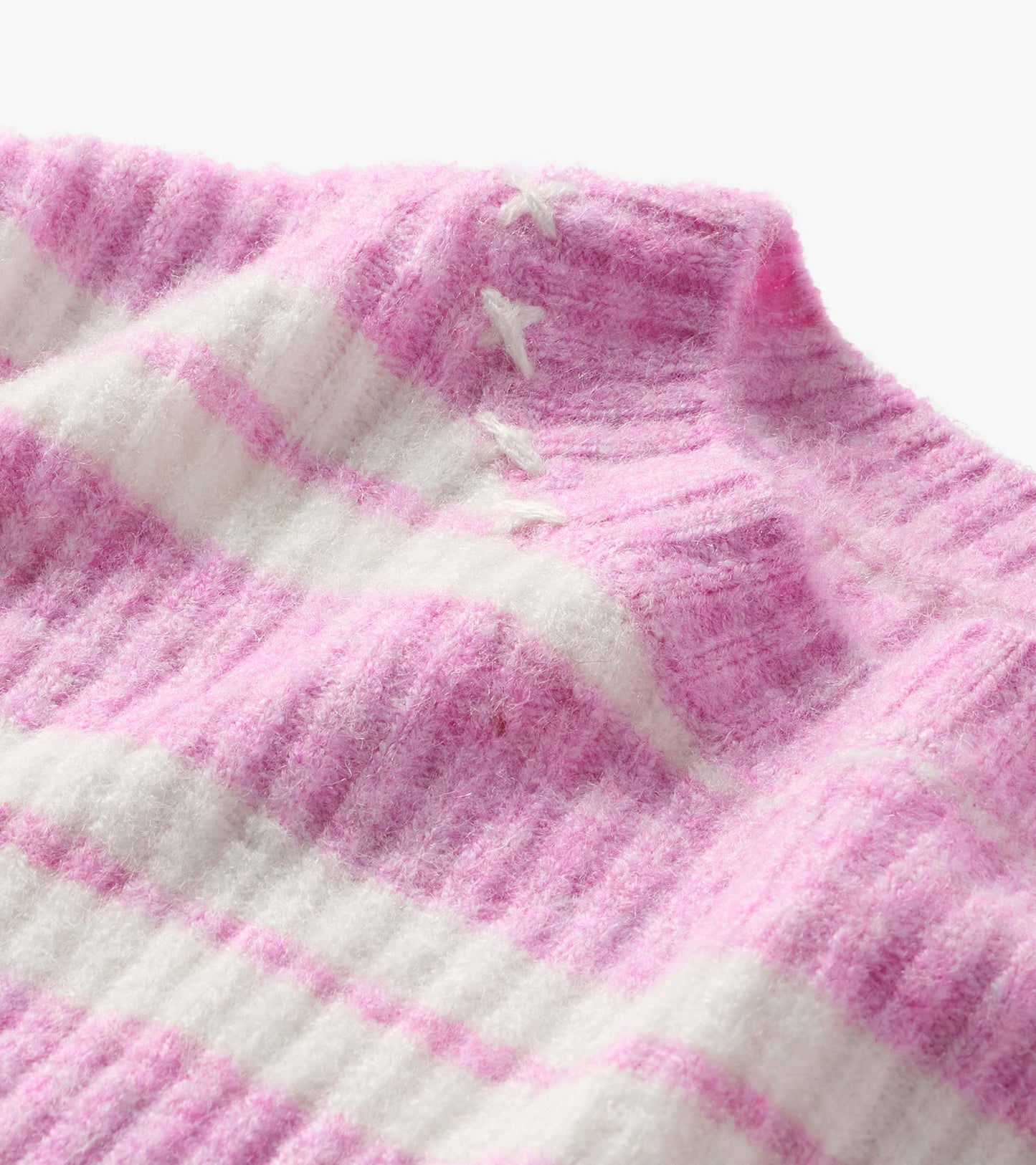 Close-up of pink and cream striped sweater with ribbed collar and lace-up neckline detail
