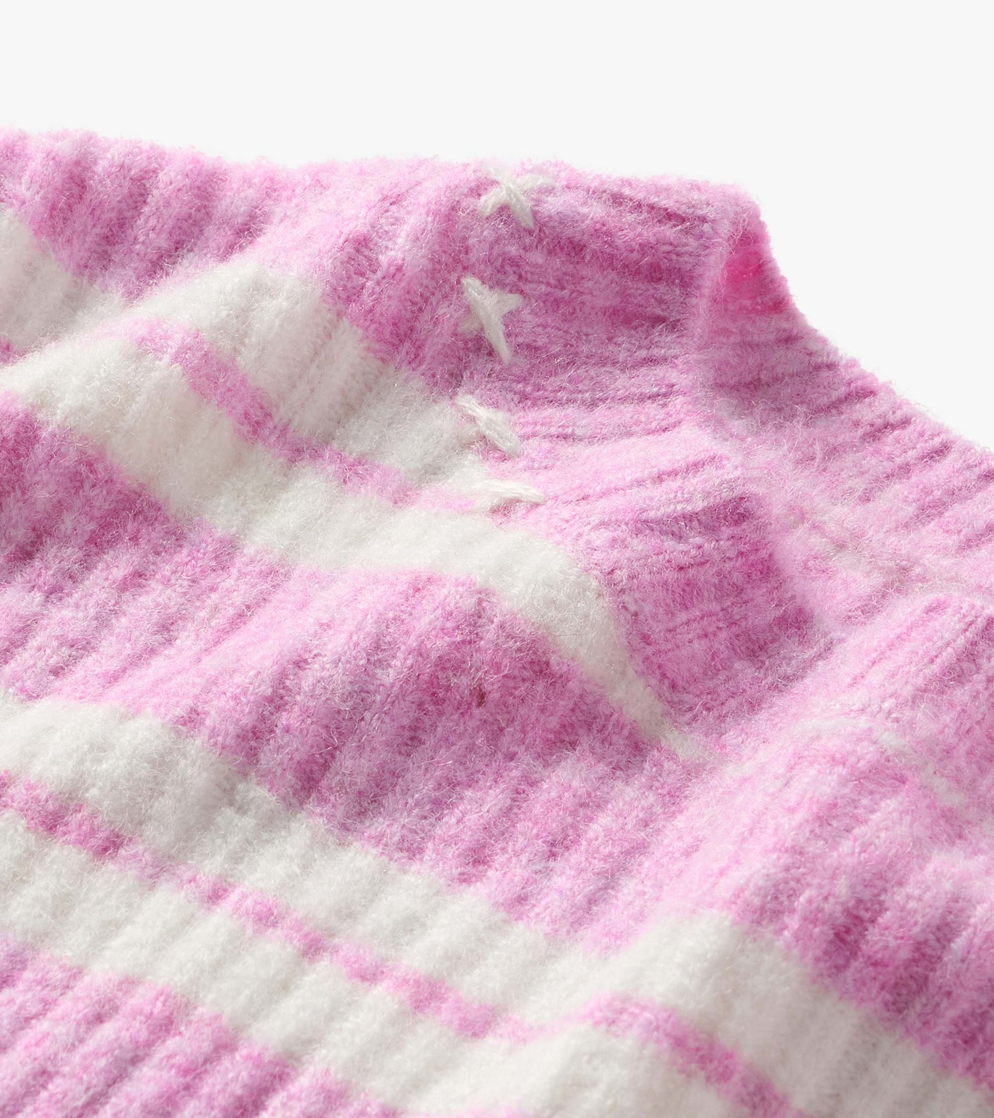 Close-up of pink and cream striped sweater with ribbed collar and lace-up neckline detail